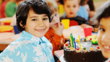 cute kids celebrating a party with cake