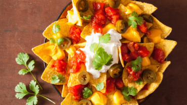 mexican nachos on a rustic wooden table top view